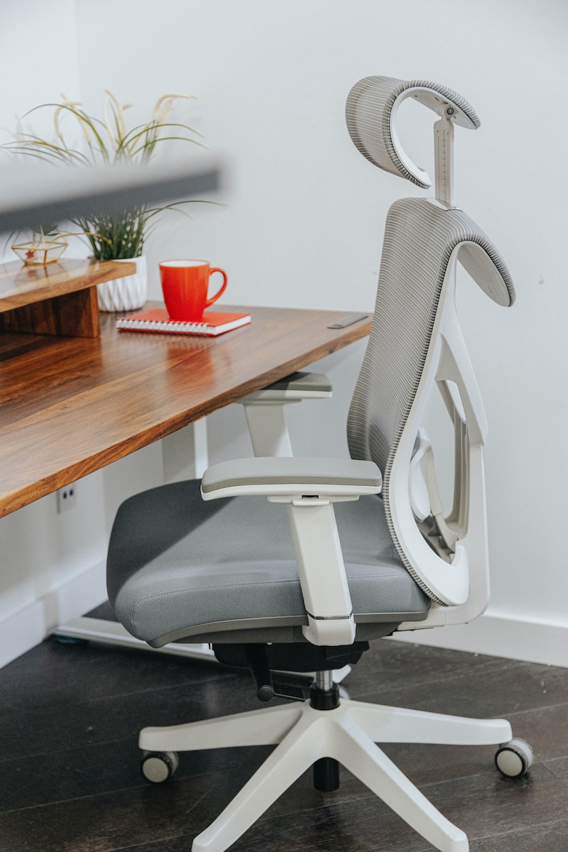 an office chair sitting on top of a wooden desk